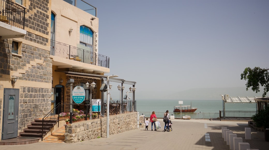 Tiberias Marina showing a coastal town as well as a family