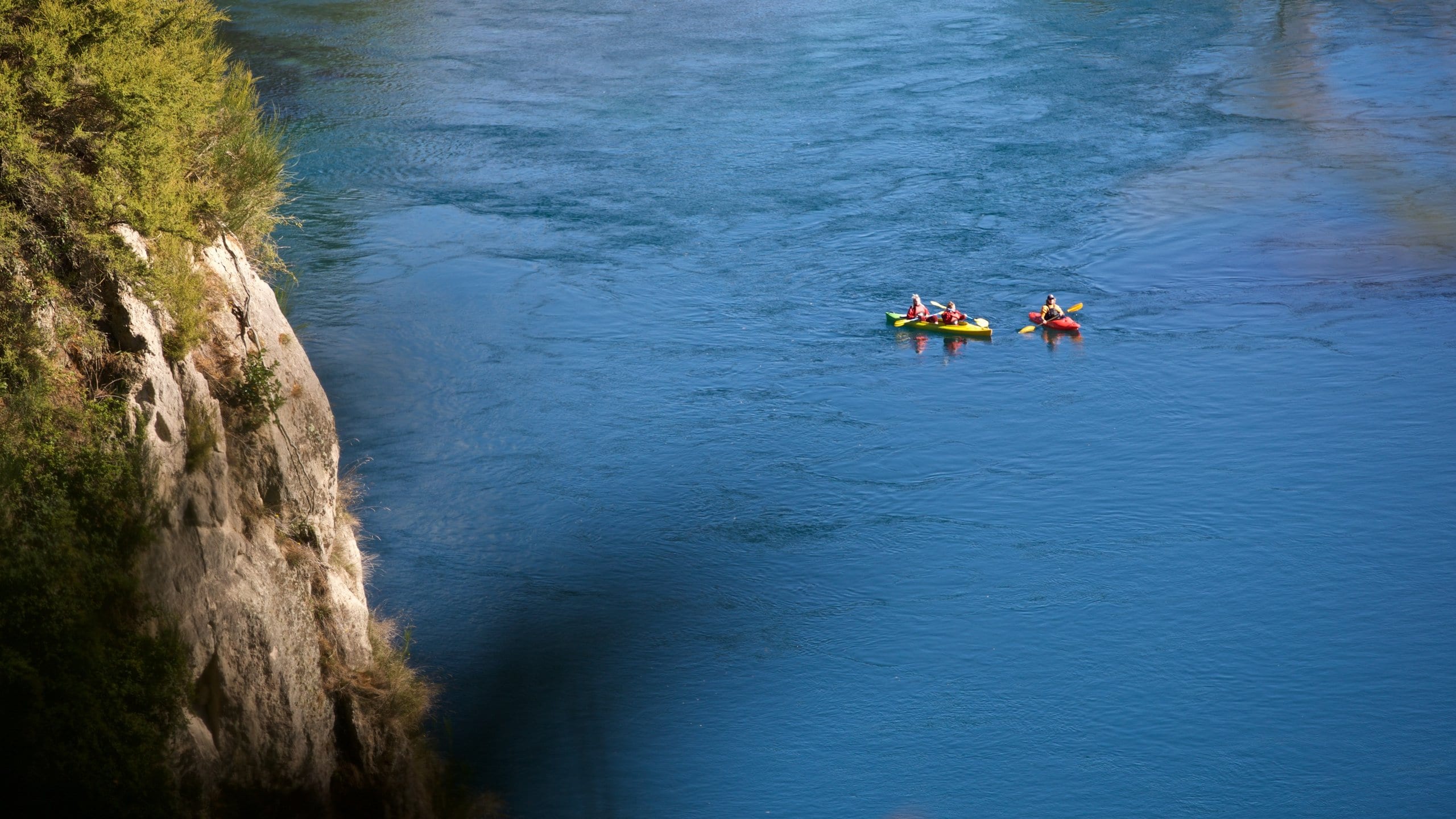 Taupo Bungy which includes kayaking or canoeing and general coastal views as well as a small group of people
