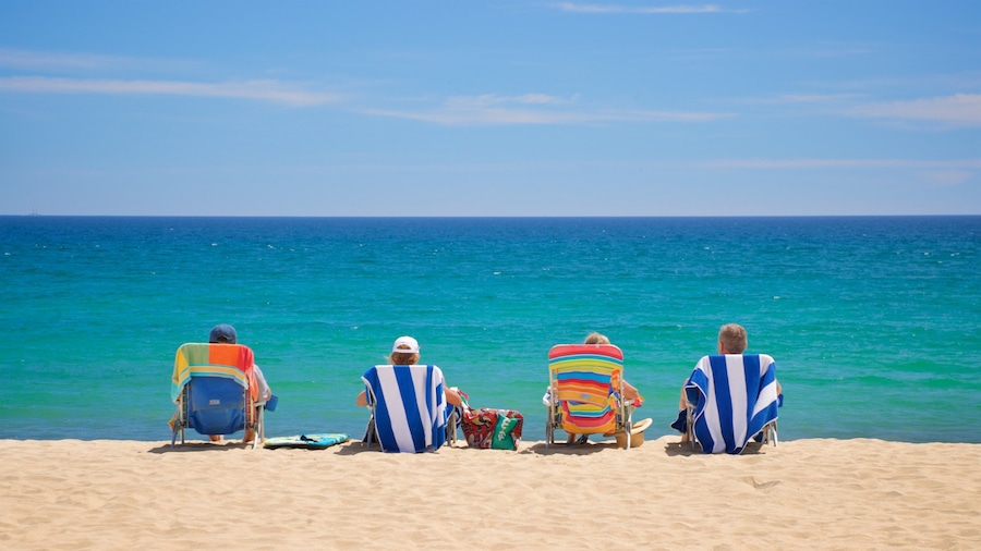 Costa Azul Beach which includes general coastal views and a beach as well as a small group of people
