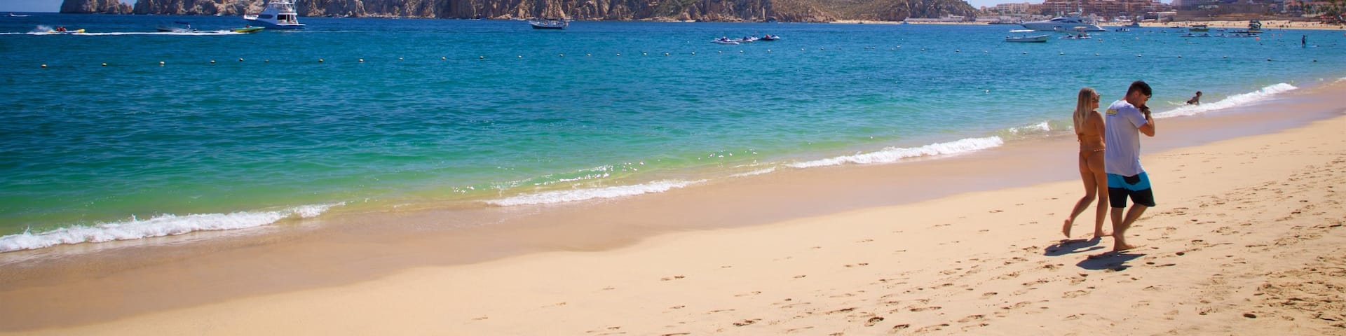 Medano Beach which includes general coastal views and a sandy beach as well as a couple