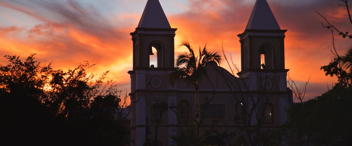 Mission of San Jose featuring a sunset and a church or cathedral