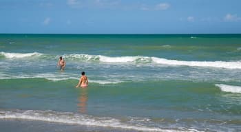 Cocoa Beach which includes general coastal views and swimming as well as a couple