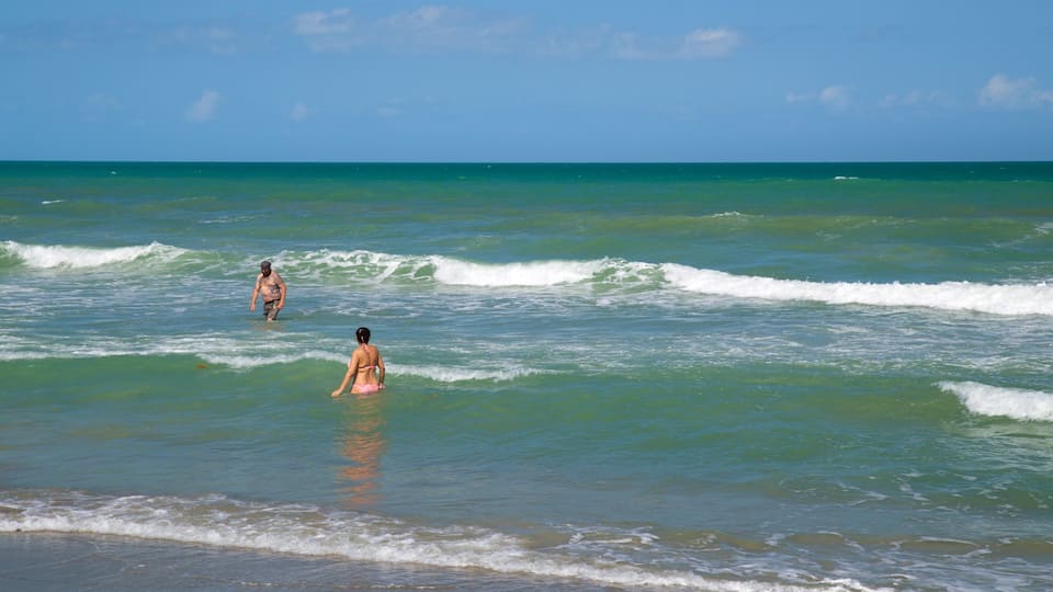 Cocoa Beach which includes general coastal views and swimming as well as a couple