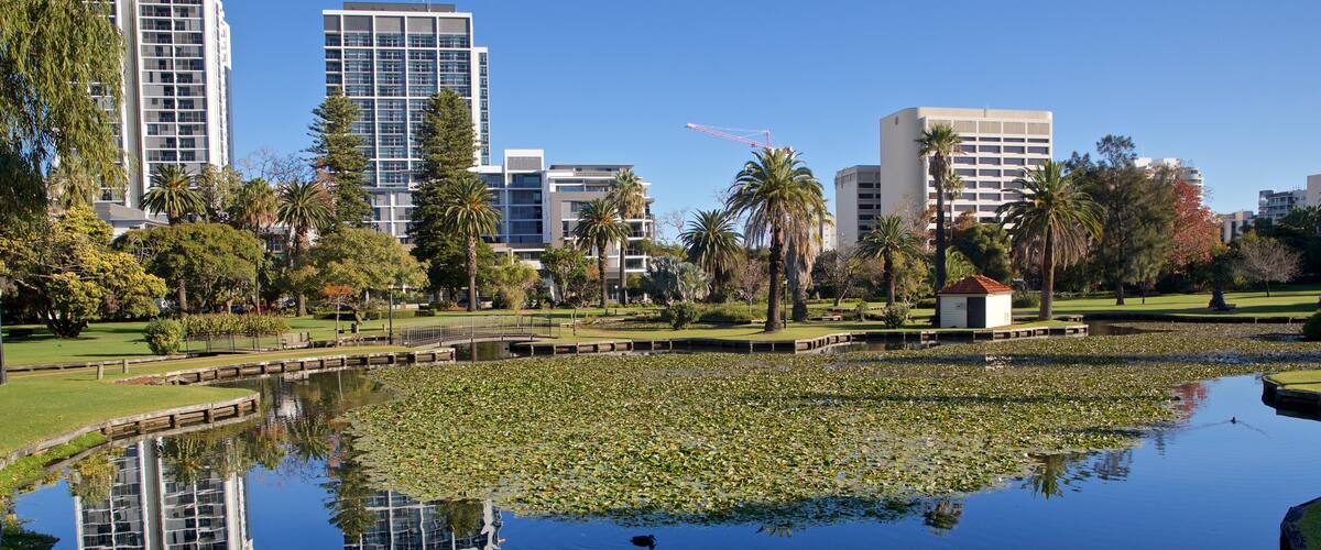 Queens Gardens featuring a pond and a park