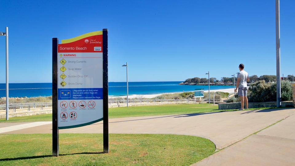 Sorrento Beach showing signage and general coastal views as well as an individual male