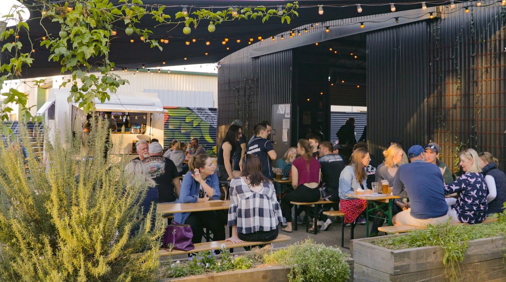 All Inn Brewing Co. showing outdoor eating as well as a small group of people