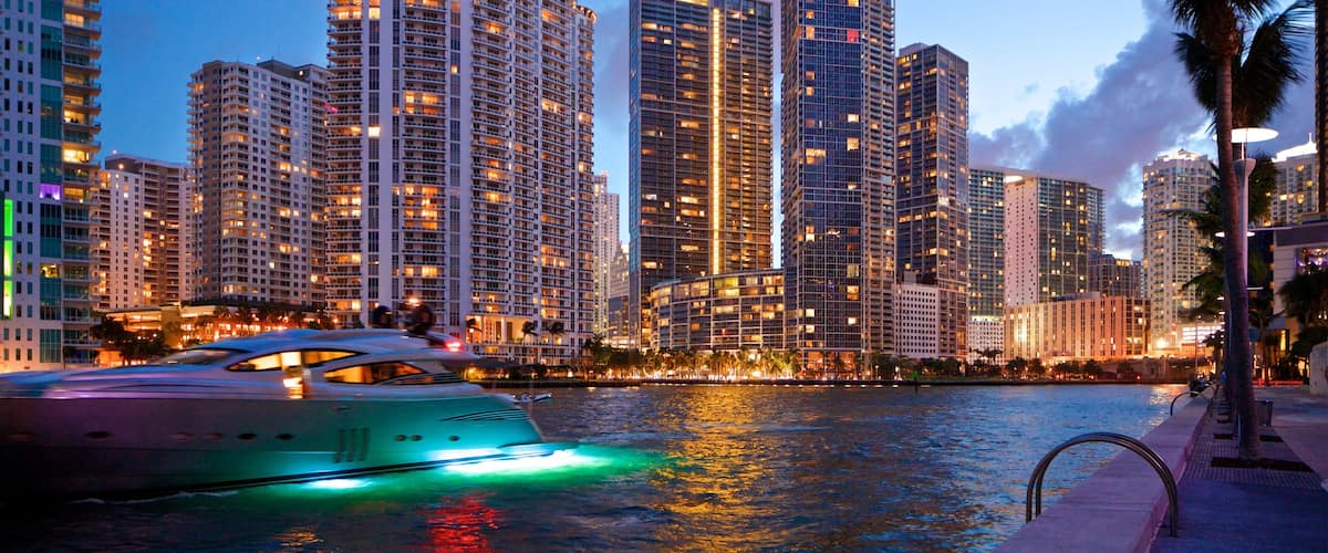Downtown Miami which includes a river or creek, night scenes and boating