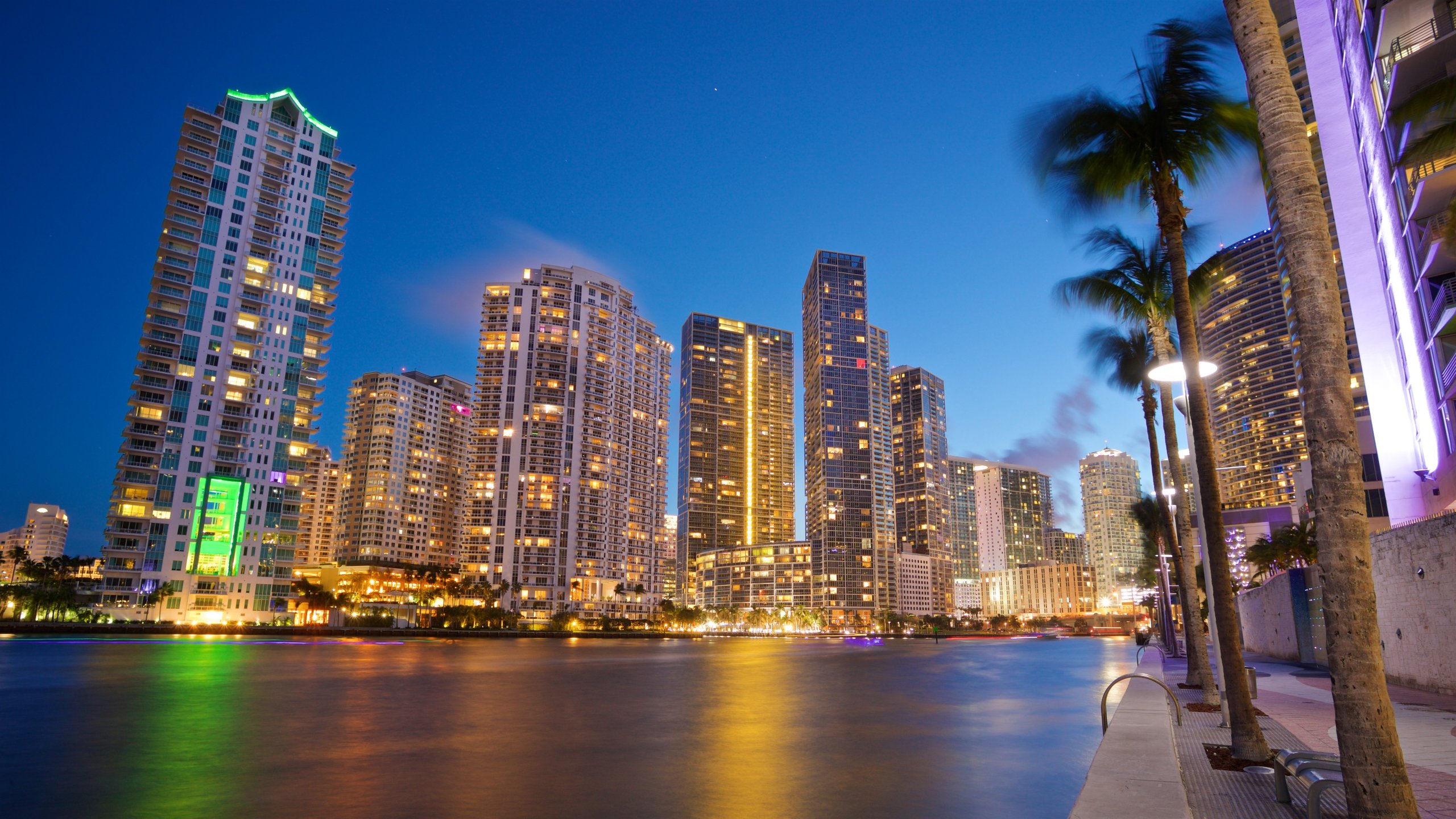 Downtown Miami which includes night scenes, a city and a river or creek