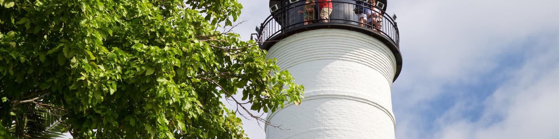 Key West Lighthouse and Keeper\'s Quarters Museum which includes a lighthouse as well as a small group of people