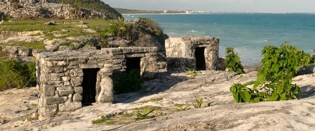 Tulum Mayan Ruins which includes building ruins and rugged coastline