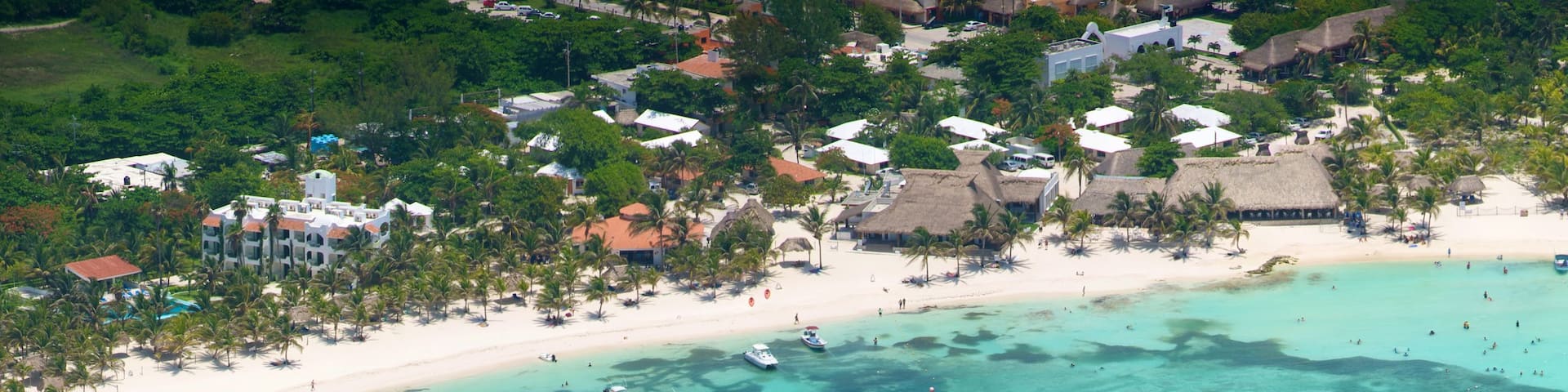 Riviera Maya which includes boating, a sandy beach and tropical scenes