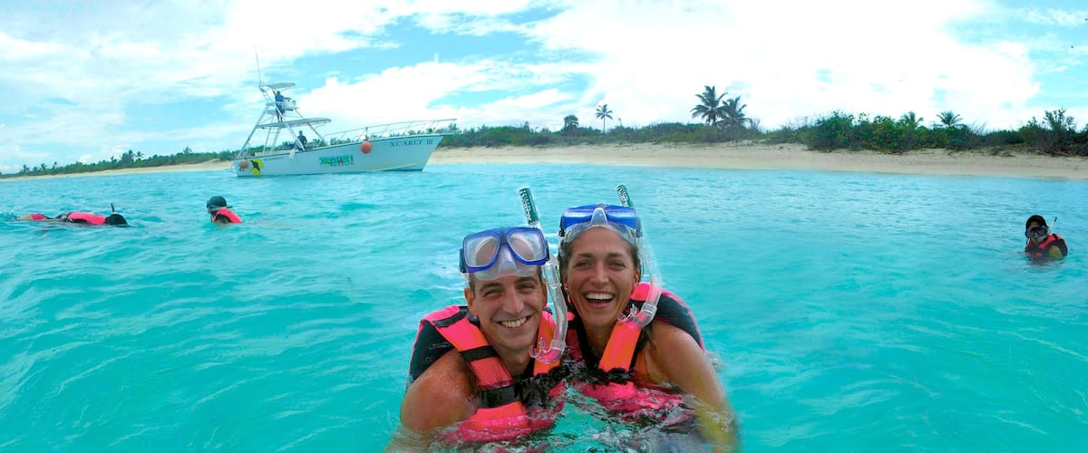 Xcaret Eco Theme Park featuring snorkeling, a sandy beach and tropical scenes