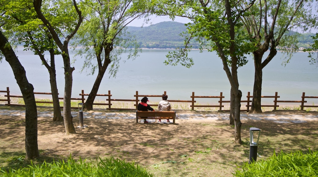 Bomun Lake showing a lake or waterhole as well as a couple