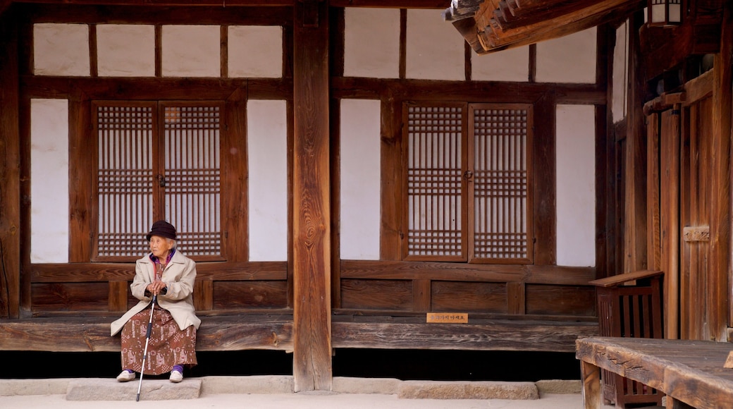 Gyeongju Gyochon Traditional Village showing heritage elements as well as an individual femail