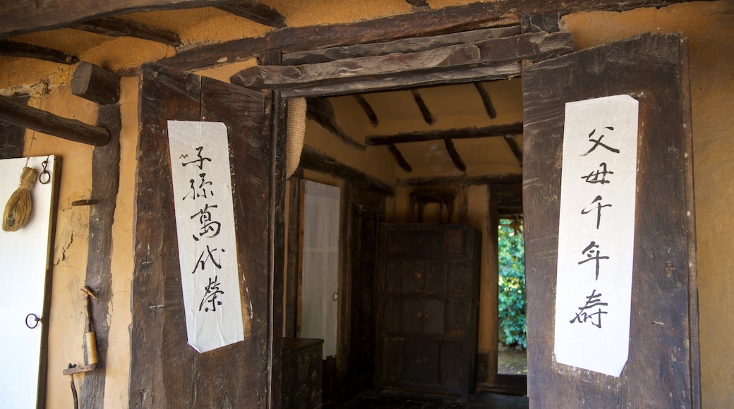 Jeju Folk Village Museum showing signage and a house