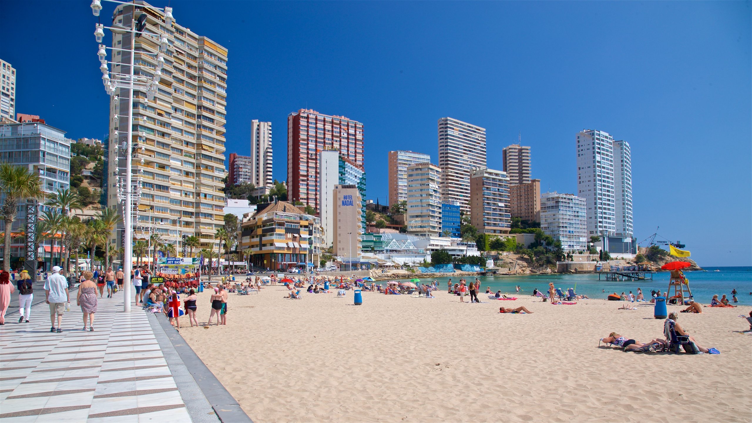 Levante Beach showing a coastal town, a sandy beach and general coastal views