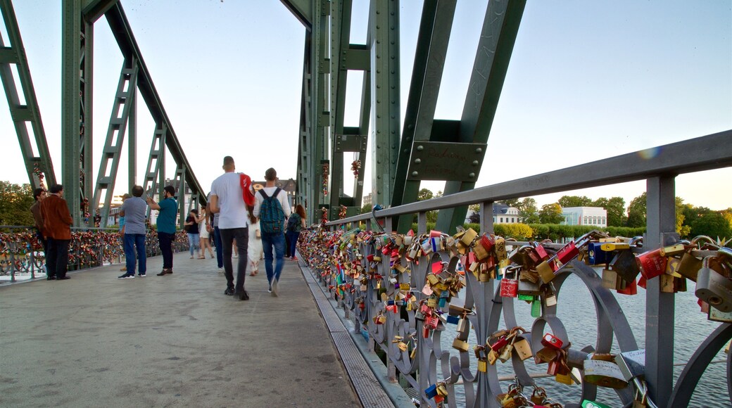 Eiserner Steg which includes a bridge, a river or creek and a sunset