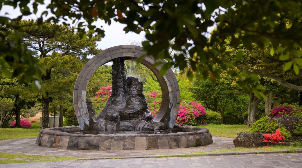 Manjanggul Lava-tube Cave which includes wildflowers, a garden and a fountain