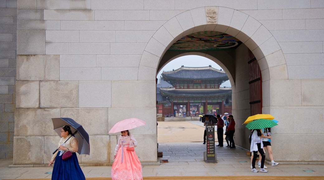 Gwanghwamun featuring street scenes as well as a small group of people