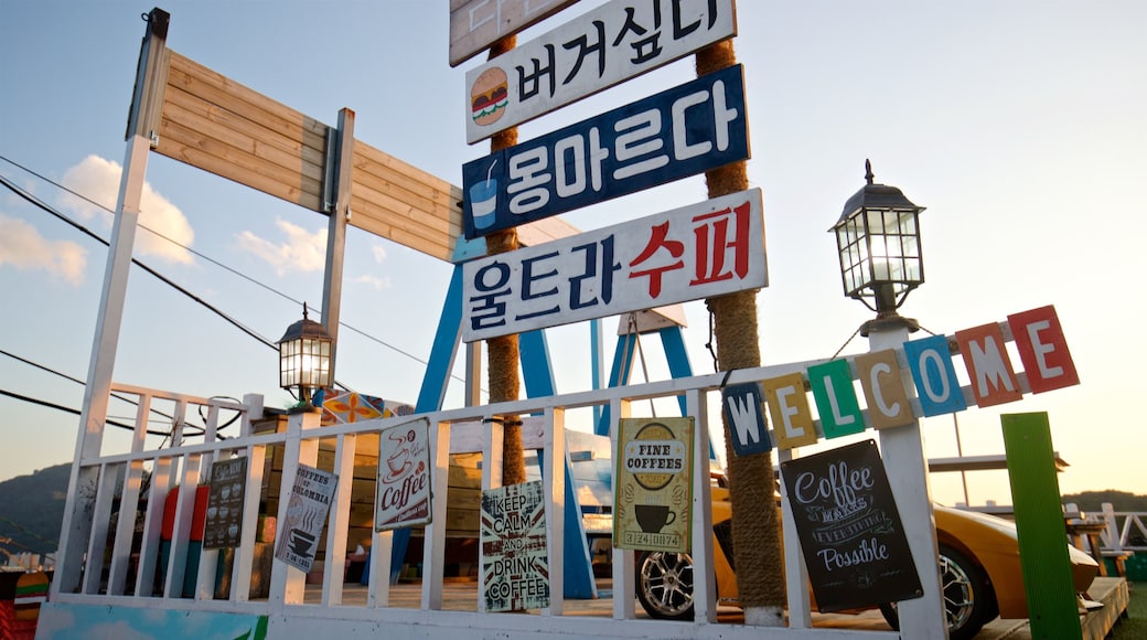 Dongpirang Wall Painting Village featuring signage and a sunset