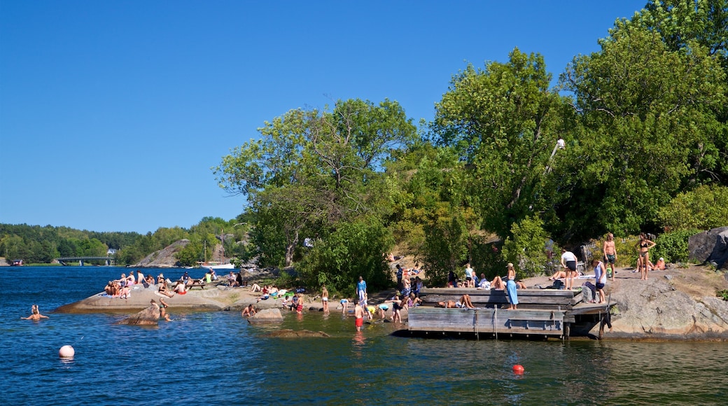 Battery Park showing a lake or waterhole as well as a small group of people