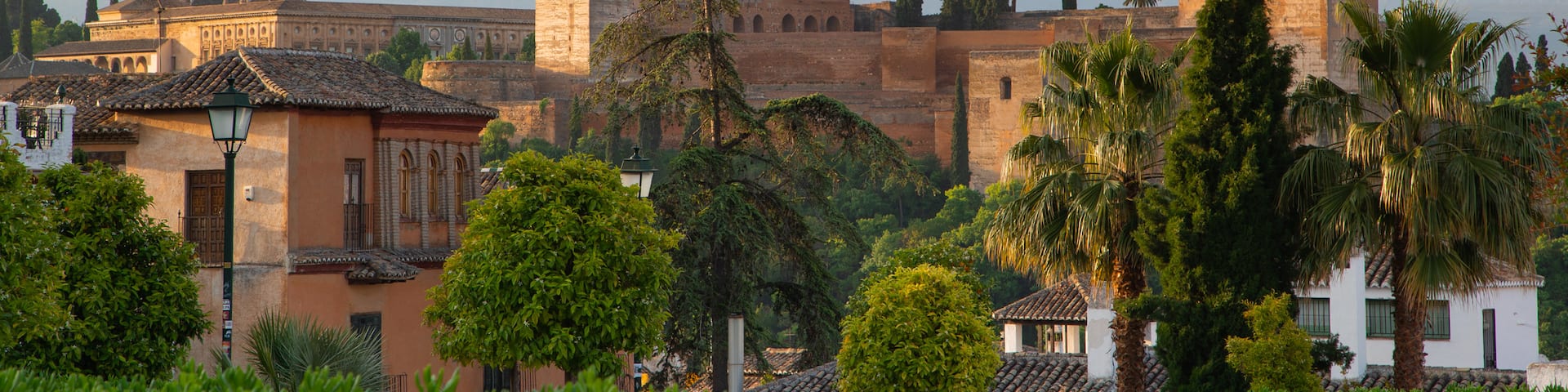 Albaicín featuring heritage architecture, landscape views and a sunset