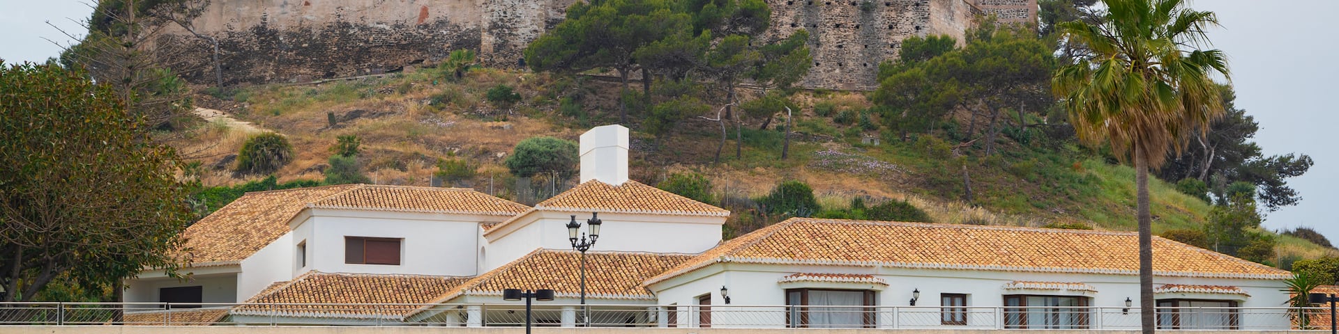 Sohail Castle showing chateau or palace, a coastal town and a beach