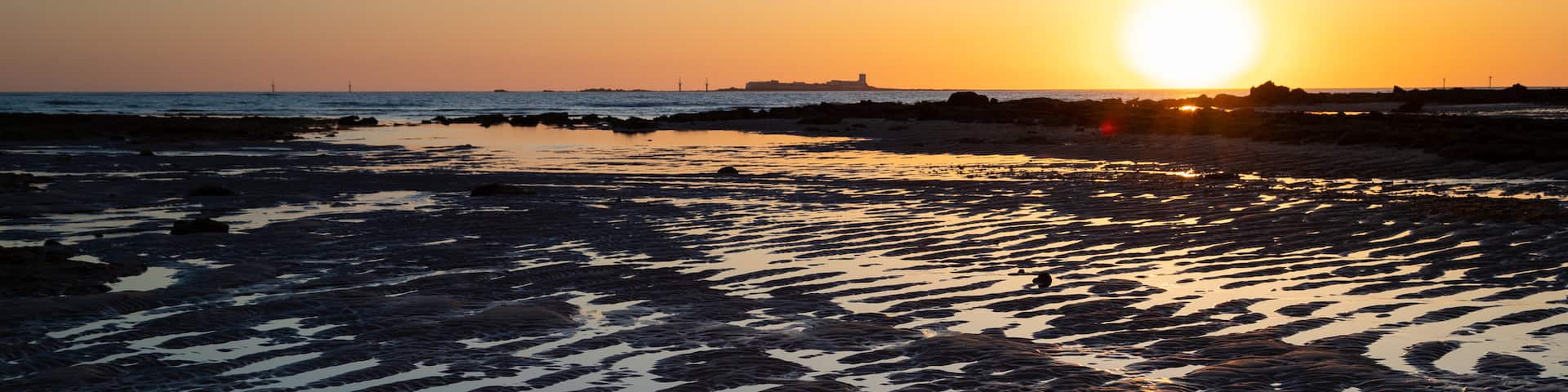 La Barrosa Beach showing a sandy beach, a sunset and general coastal views