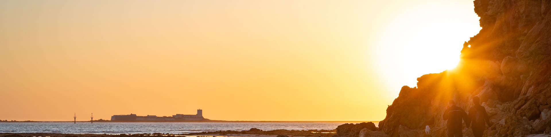 La Barrosa Beach featuring a sandy beach, a sunset and general coastal views