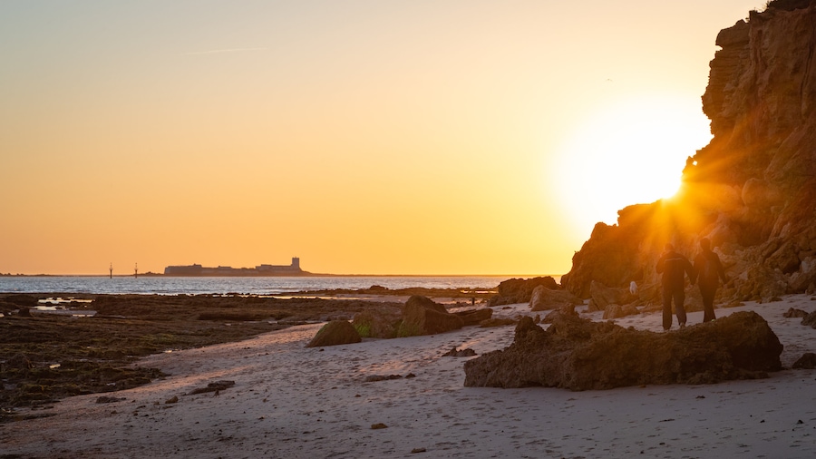 La Barrosa Beach featuring a sandy beach, a sunset and general coastal views
