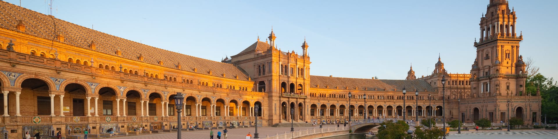 Plaza de Espana featuring a sunset, heritage architecture and a river or creek