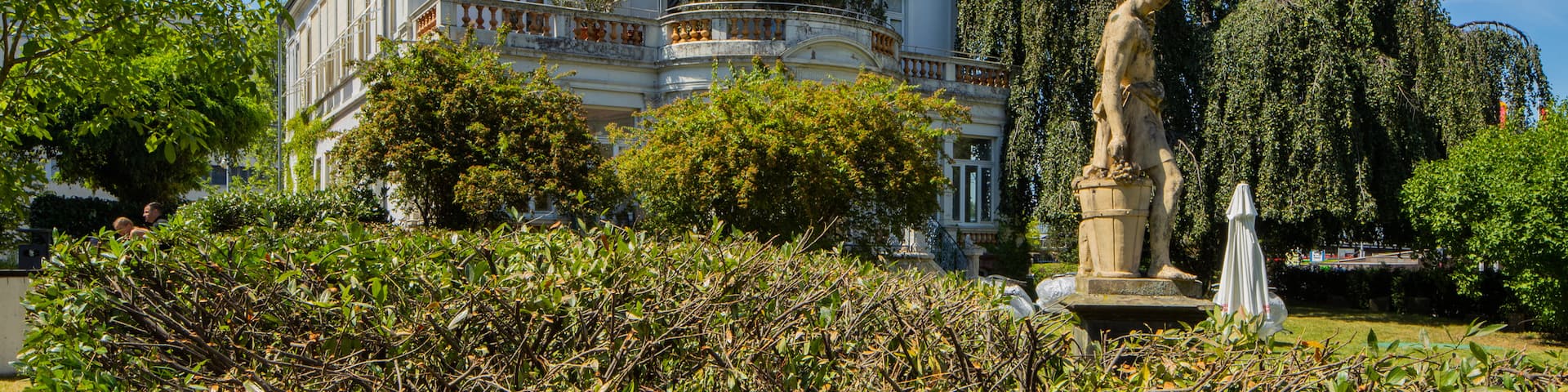 Goethe Institute featuring a house, a statue or sculpture and a garden