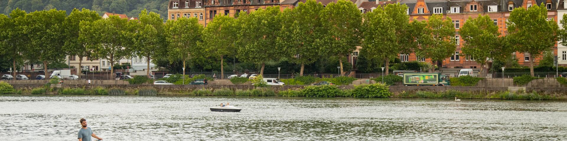 Leinpfad showing a river or creek and a park as well as a small group of people