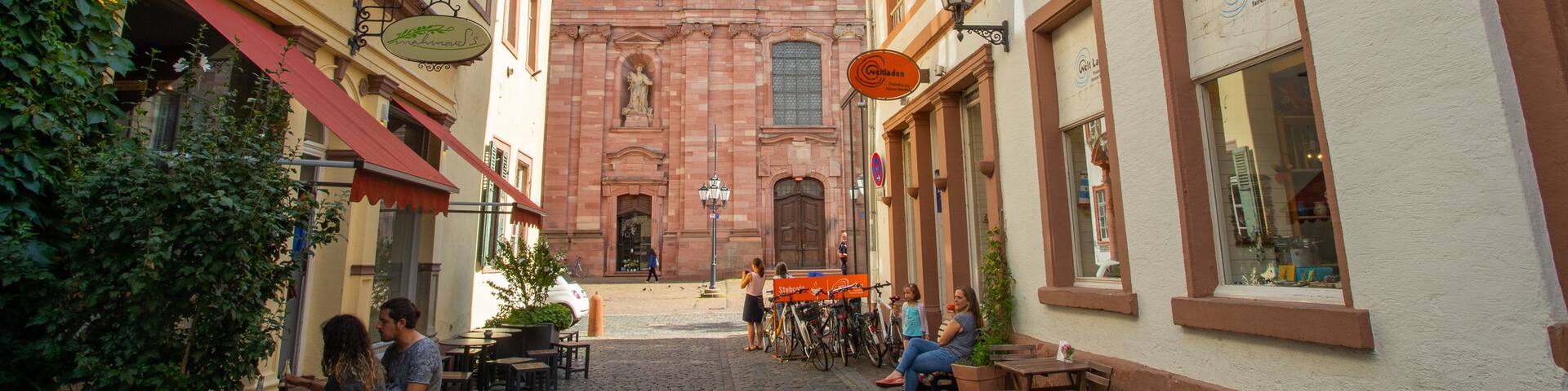 Jesuitenkirche which includes outdoor eating, heritage elements and a church or cathedral