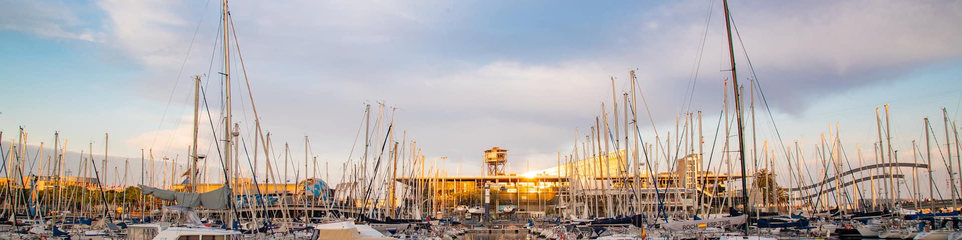 Port Vell which includes a sunset and a bay or harbor