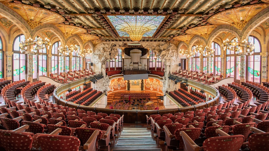 Interior view of Palau de la Música Catalana in Barcelona, featuring ornate stained glass and mosaics.