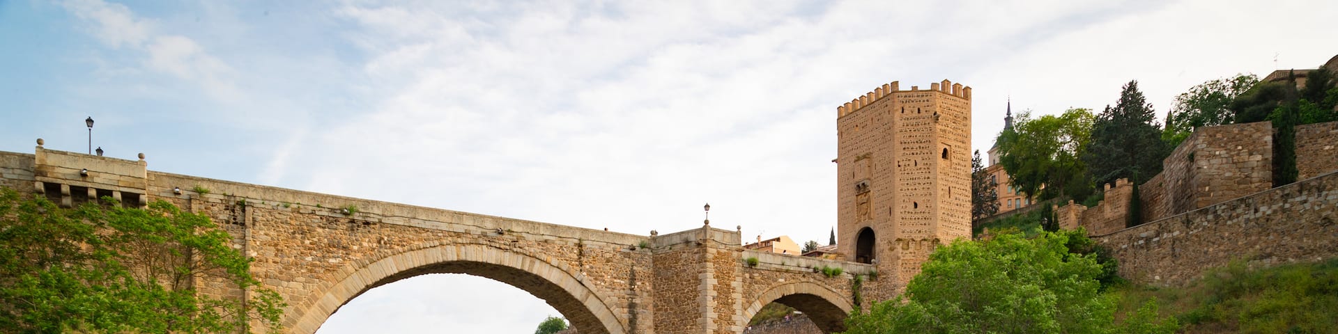 Puente de Alcantara featuring a river or creek, a bridge and heritage elements