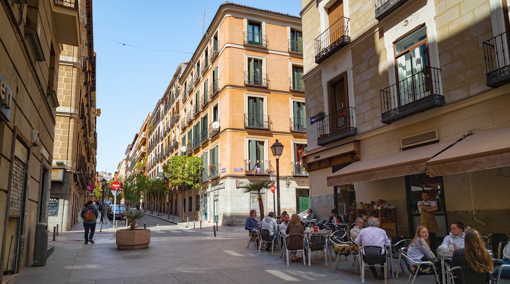 Malasana showing outdoor eating and a city as well as a small group of people