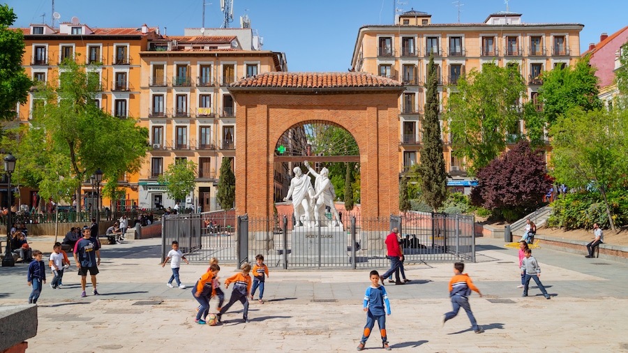 Malasana which includes a square or plaza and a statue or sculpture as well as children