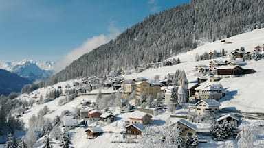 Davos which includes mountains, snow and a small town or village