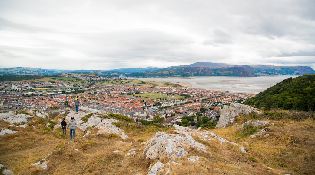 Pen-y-Dinas Hillfort featuring a coastal town and landscape views as well as a couple