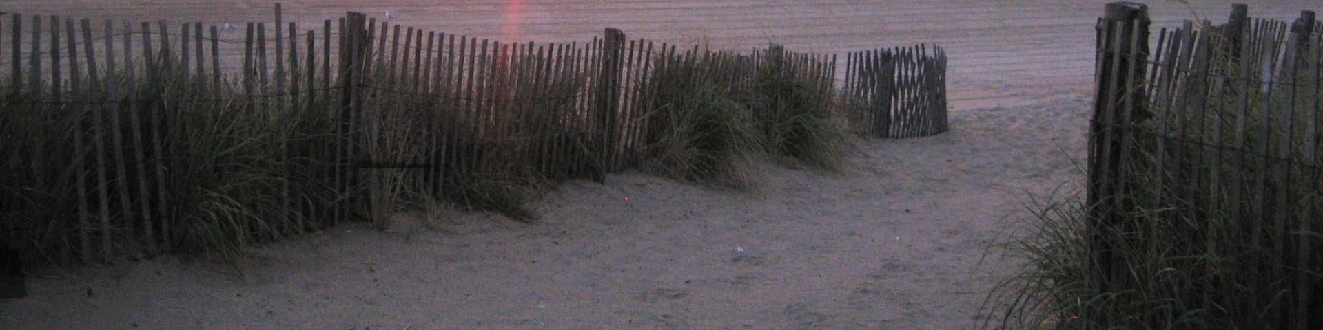Rehoboth Beach featuring general coastal views, a sunset and a beach