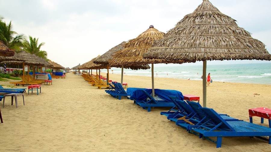 Cua Dai Beach showing tropical scenes, a luxury hotel or resort and a sandy beach