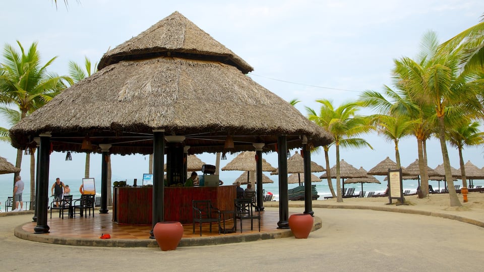 Cua Dai Beach which includes a luxury hotel or resort, a sandy beach and tropical scenes