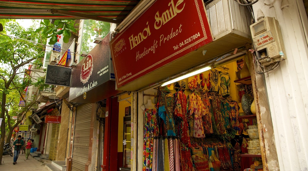 Hoan Kiem showing a city, signage and street scenes