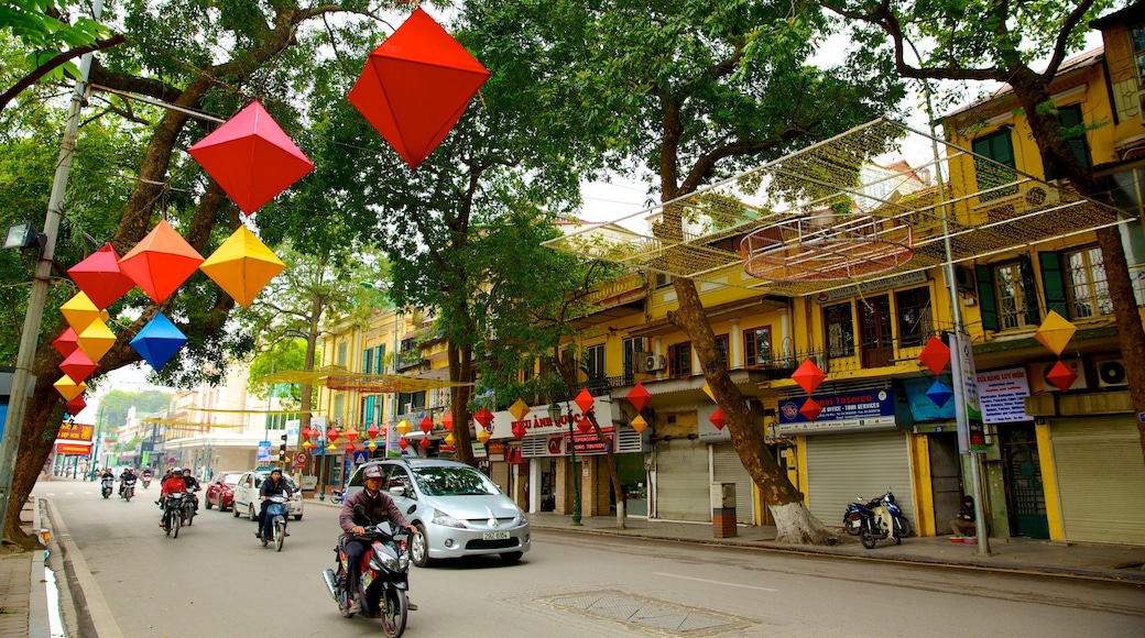 Old Quarter - Hoan Kiem Lake showing street scenes, signage and motorcycle riding