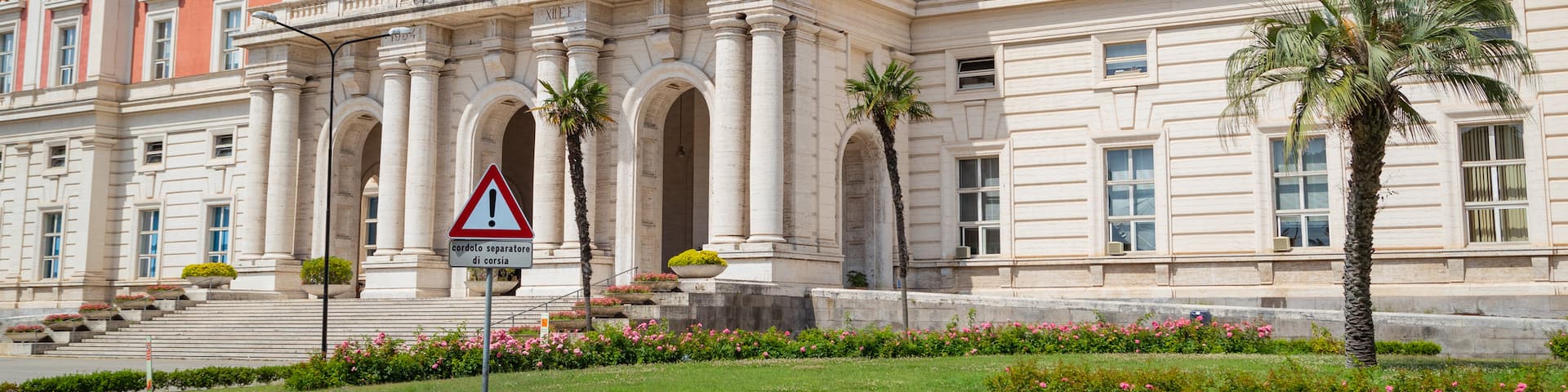 Zona Ospedaliera showing heritage architecture, a garden and flowers