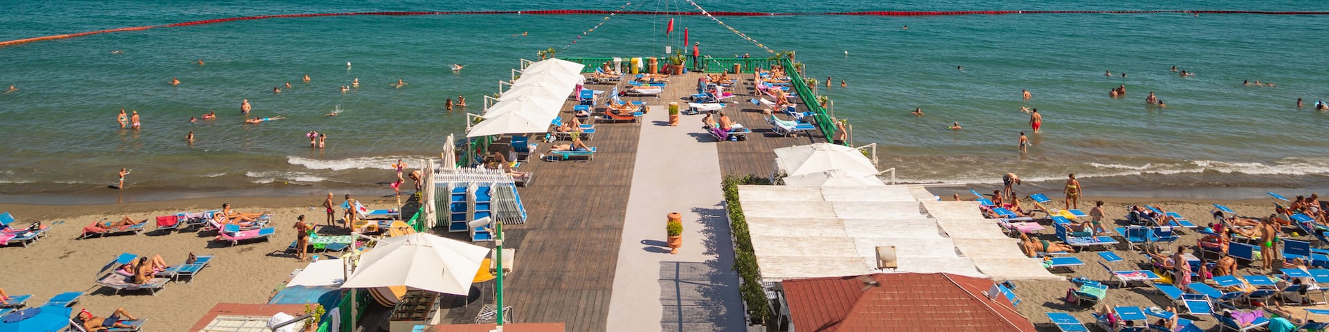Posillipo featuring a sandy beach and general coastal views as well as a small group of people