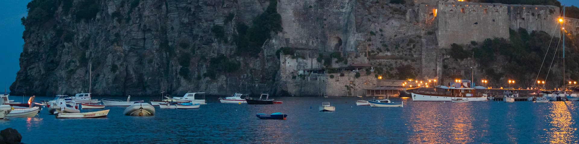Aragonese Castle which includes general coastal views, night scenes and heritage elements