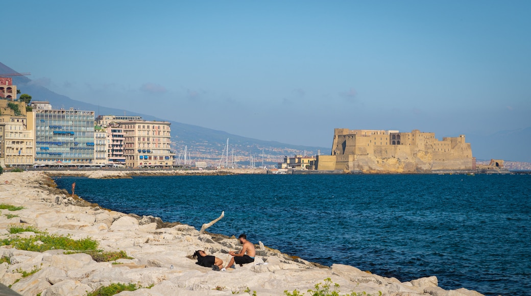 Via Caracciolo e Lungomare di Napoli which includes a coastal town, heritage elements and rugged coastline